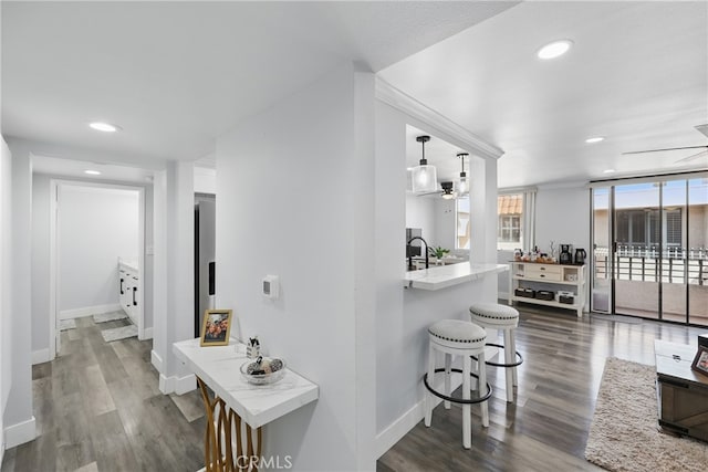 hall with baseboards, recessed lighting, and wood finished floors