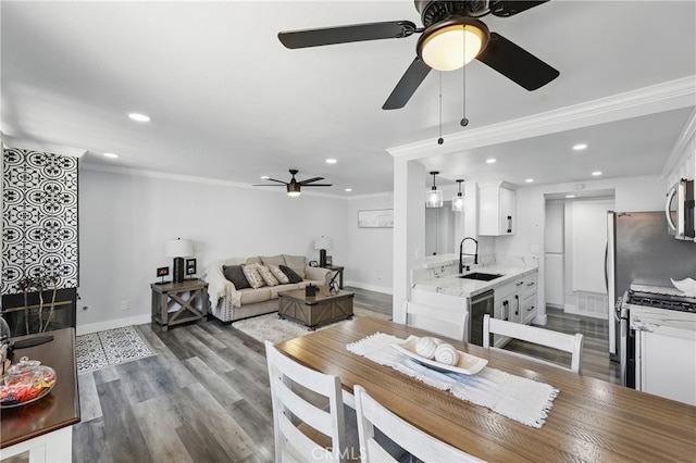 dining space with ceiling fan, ornamental molding, baseboards, and dark wood-type flooring