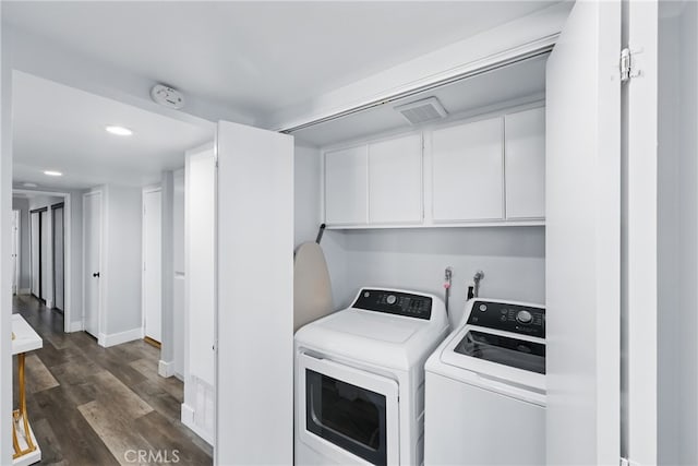 laundry room featuring cabinet space, recessed lighting, baseboards, dark wood-type flooring, and washer and clothes dryer