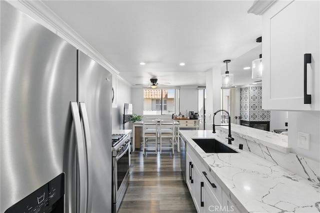 kitchen featuring appliances with stainless steel finishes, a sink, white cabinetry, a ceiling fan, and recessed lighting