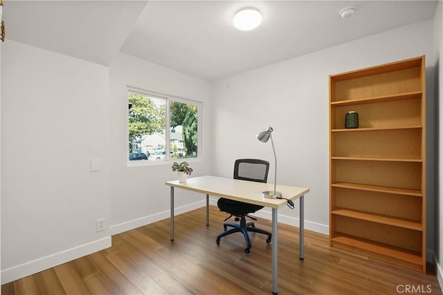 office with baseboards and wood finished floors