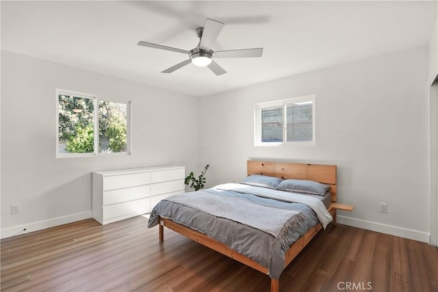 bedroom featuring baseboards, a ceiling fan, and wood finished floors