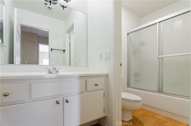 653 Oak Run Trl Unit Tl402, Oak Park, CA 91377 - full bathroom with visible vents, vanity, wood finished floors, toilet, and enclosed tub / shower combo