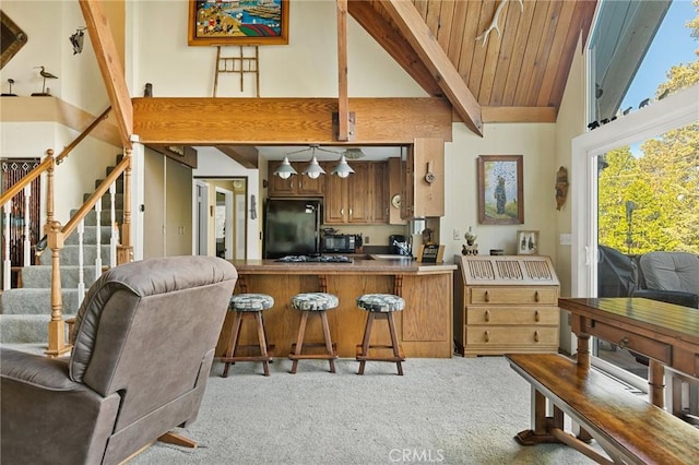 256 B Ln, Lake Arrowhead, CA 92352 - kitchen featuring black appliances, high vaulted ceiling, light colored carpet, brown cabinetry, and beamed ceiling