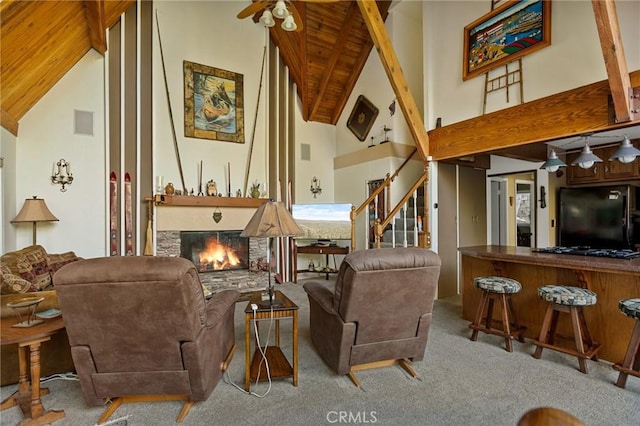 256 B Ln, Lake Arrowhead, CA 92352 - carpeted living area with high vaulted ceiling, a fireplace, a wooden ceiling with exposed beams, stairs, and a ceiling fan