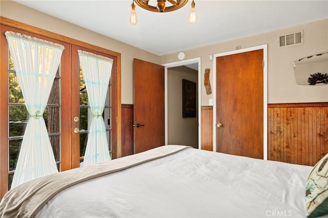 256 B Ln, Lake Arrowhead, CA 92352 - bedroom featuring a wainscoted wall, french doors, wood walls, and access to exterior