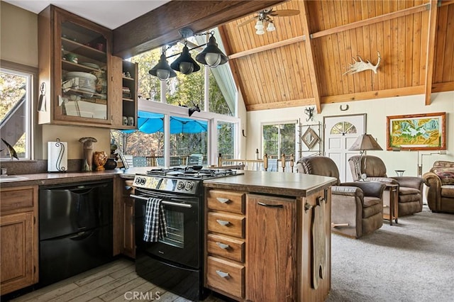 256 B Ln, Lake Arrowhead, CA 92352 - kitchen featuring black appliances, healthy amount of natural light, a peninsula, beamed ceiling, and dark countertops