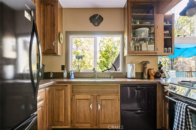 256 B Ln, Lake Arrowhead, CA 92352 - kitchen featuring black appliances, brown cabinets, healthy amount of natural light, and glass insert cabinets
