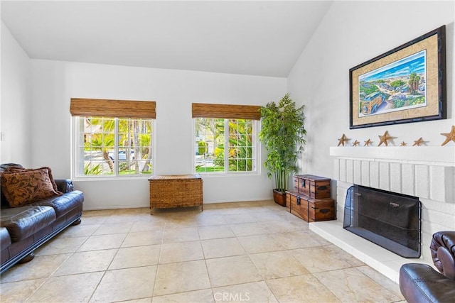 2204 Recodo Ct, Carlsbad, CA 92009 - tiled living room with vaulted ceiling and a fireplace with raised hearth