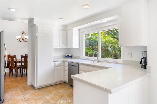 2204 Recodo Ct, Carlsbad, CA 92009 - kitchen featuring appliances with stainless steel finishes, a chandelier, light countertops, white cabinetry, and a peninsula