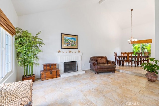 2204 Recodo Ct, Carlsbad, CA 92009 - living area with high vaulted ceiling, healthy amount of natural light, a chandelier, a fireplace, and beamed ceiling
