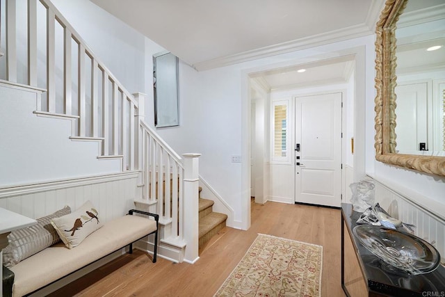 entryway featuring crown molding, recessed lighting, stairway, and light wood finished floors