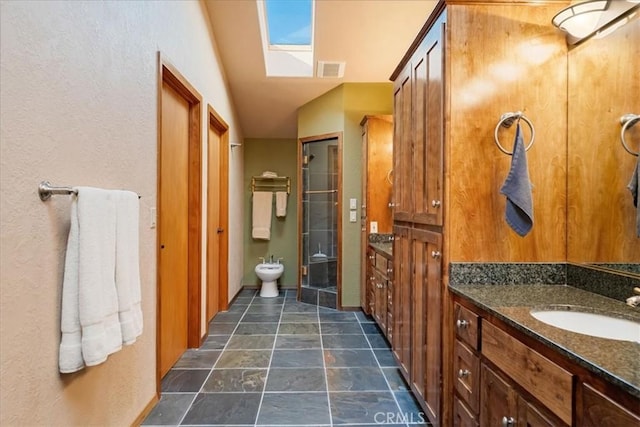 15516 Valley View Dr, Weed, CA 96094 - full bath featuring vanity, a stall shower, vaulted ceiling with skylight, a bidet, and visible vents