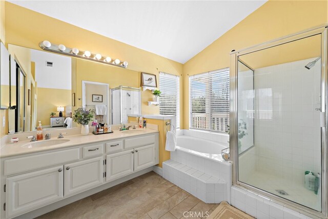 10 Cambridge Ct, Coto De Caza, CA 92679 - bathroom with lofted ceiling, a shower stall, a bath, double vanity, and tile patterned flooring