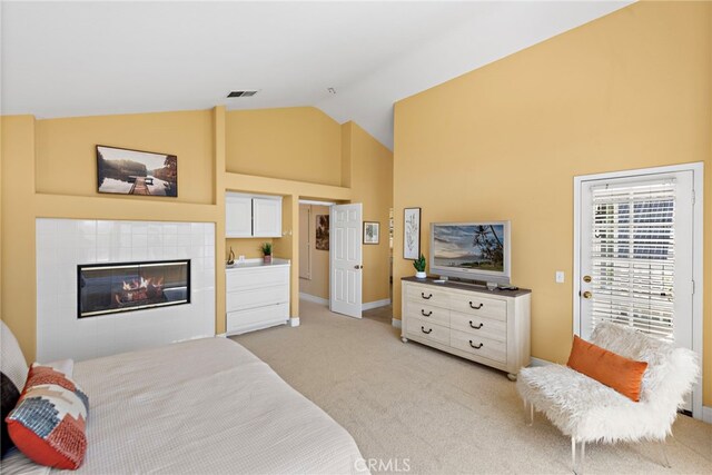 10 Cambridge Ct, Coto De Caza, CA 92679 - bedroom with high vaulted ceiling, light carpet, a tiled fireplace, and baseboards