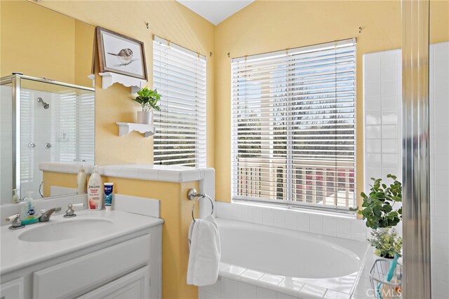 10 Cambridge Ct, Coto De Caza, CA 92679 - bathroom featuring healthy amount of natural light, a garden tub, tiled shower, and vanity