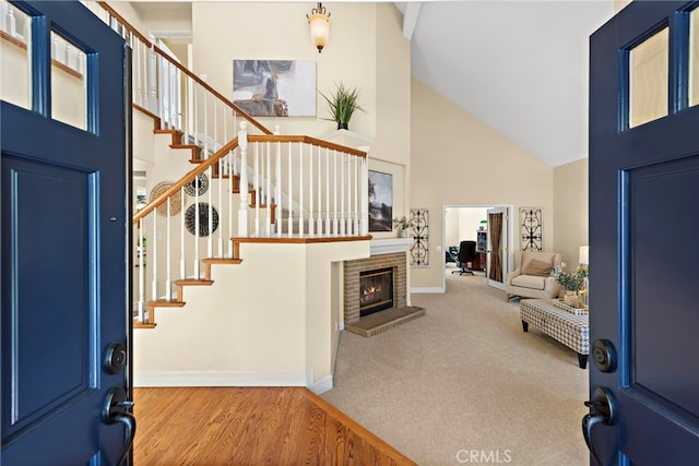 10 Cambridge Ct, Coto De Caza, CA 92679 - entryway with high vaulted ceiling, baseboards, stairs, a fireplace, and wood finished floors