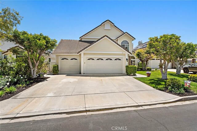 10 Cambridge Ct, Coto De Caza, CA 92679 - traditional home with an attached garage, concrete driveway, and a front lawn