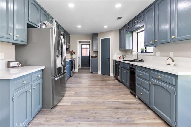 5703 Violet Ct, Atwater, CA 95301 - kitchen with a sink, light wood-style floors, recessed lighting, dishwasher, and stainless steel refrigerator with ice dispenser