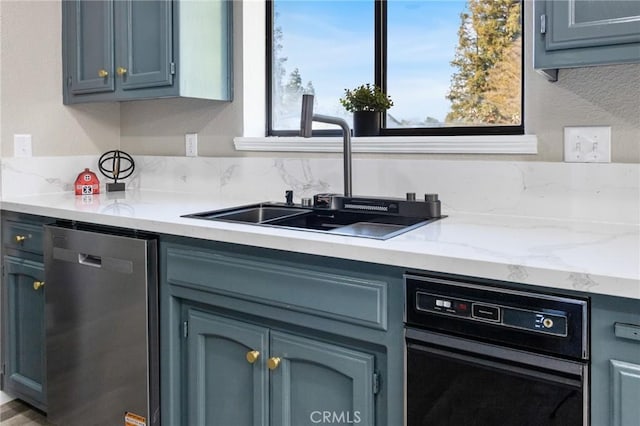 5703 Violet Ct, Atwater, CA 95301 - kitchen featuring dishwasher, a sink, and light stone counters