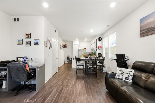 living room featuring visible vents, recessed lighting, and dark wood-type flooring