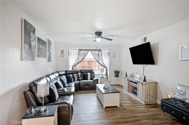 living room featuring visible vents, wood finished floors, and ceiling fan