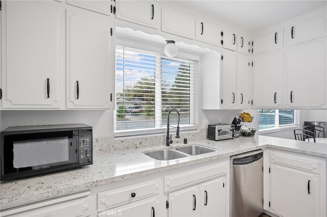 kitchen featuring dishwasher, black microwave, white cabinetry, and a sink
