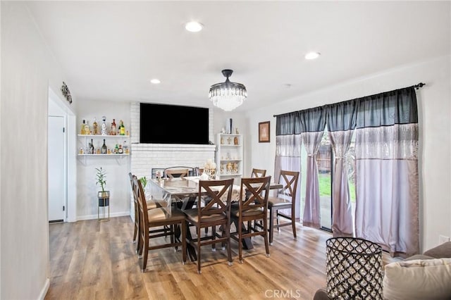 dining area featuring baseboards, an inviting chandelier, wood finished floors, and recessed lighting