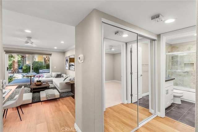 interior space with wood finished floors, recessed lighting, and ornamental molding