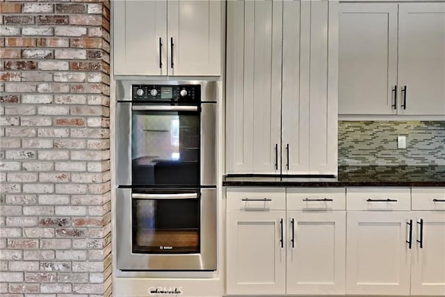 2100 Sherwood Ave Unit A, Modesto, CA 95350 - kitchen featuring dark stone counters, white cabinetry, backsplash, and stainless steel double oven