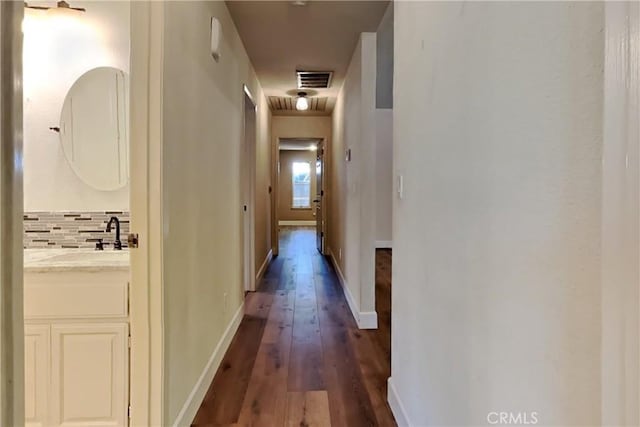 2100 Sherwood Ave Unit A, Modesto, CA 95350 - corridor with baseboards, visible vents, a sink, and dark wood finished floors