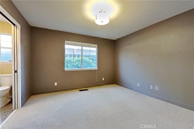 2100 Sherwood Ave Unit A, Modesto, CA 95350 - empty room with baseboards, visible vents, and carpet flooring