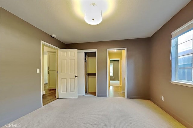 2100 Sherwood Ave Unit A, Modesto, CA 95350 - unfurnished bedroom featuring light carpet, baseboards, and a closet