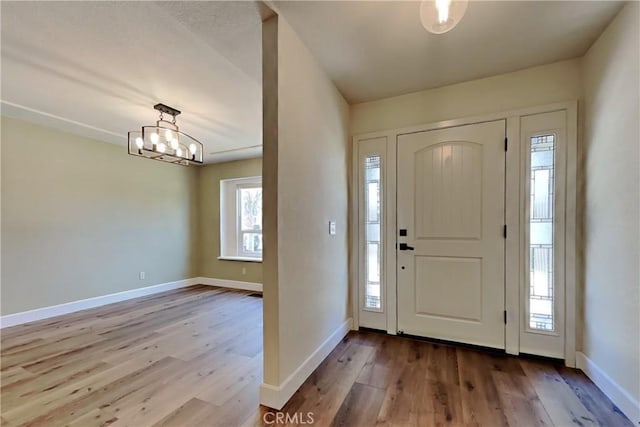 2100 Sherwood Ave Unit A, Modesto, CA 95350 - entryway featuring baseboards, wood finished floors, and an inviting chandelier