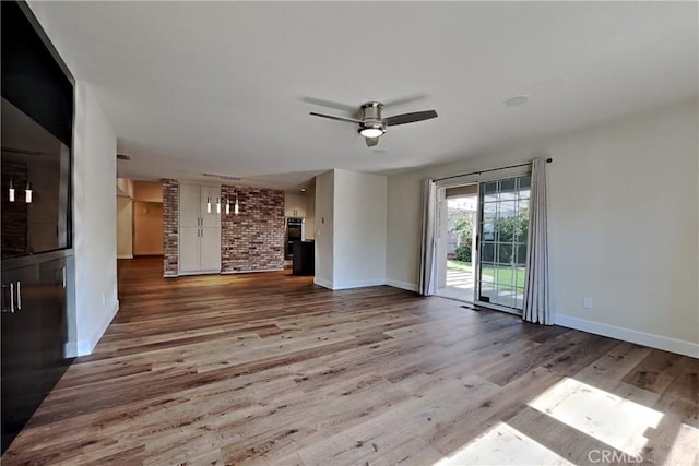 2100 Sherwood Ave Unit A, Modesto, CA 95350 - unfurnished living room featuring baseboards, wood finished floors, and a ceiling fan