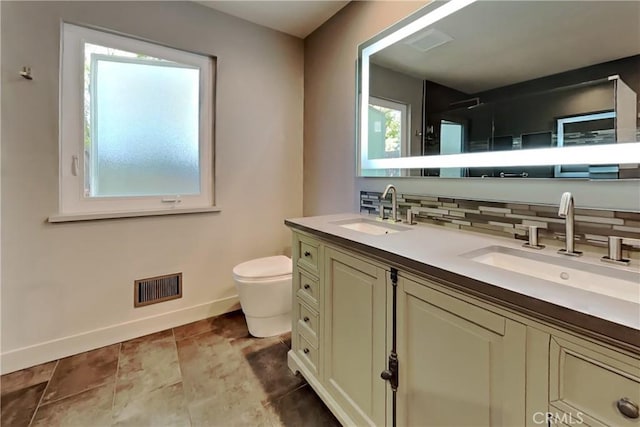 2100 Sherwood Ave Unit A, Modesto, CA 95350 - bathroom featuring decorative backsplash, a sink, toilet, and visible vents
