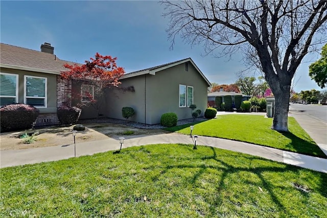 2100 Sherwood Ave Unit A, Modesto, CA 95350 - view of side of home featuring stucco siding and a yard