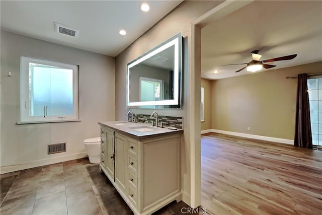 2100 Sherwood Ave Unit A, Modesto, CA 95350 - bathroom featuring a sink, baseboards, ceiling fan, and visible vents