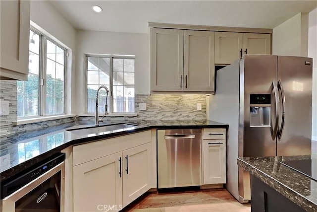 2100 Sherwood Ave Unit A, Modesto, CA 95350 - kitchen with decorative backsplash, stainless steel appliances, recessed lighting, dark stone countertops, and a sink