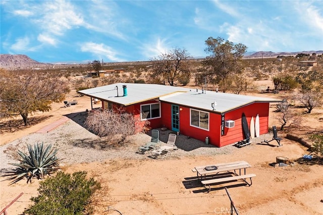 exterior space featuring a rural view, a mountain view, and view of desert