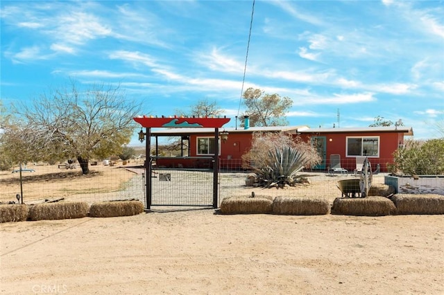 ranch-style home with fence and a gate