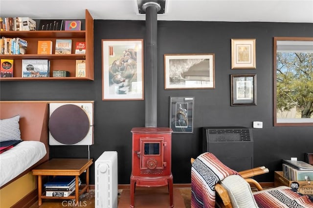 living area with a wood stove and baseboards