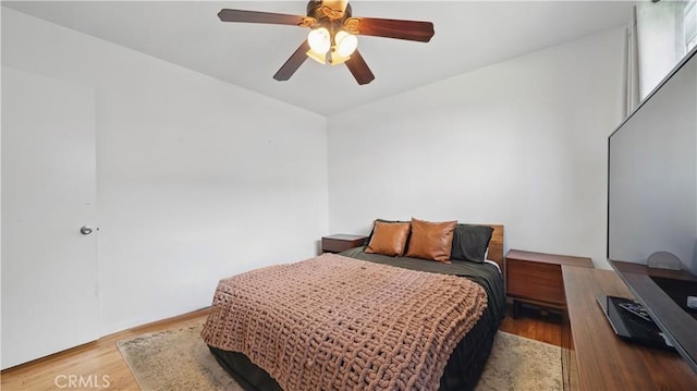bedroom with wood finished floors and ceiling fan