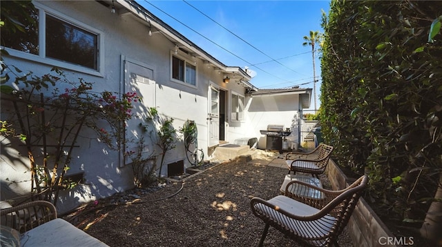 view of home's exterior featuring stucco siding and fence