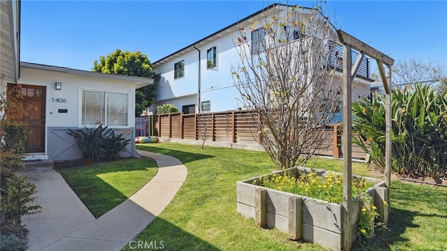 view of yard with a garden and fence