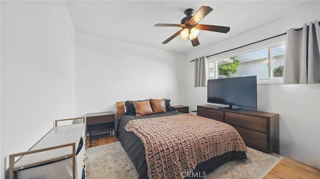 bedroom with wood finished floors and a ceiling fan