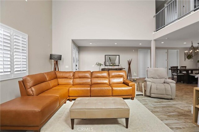 13083 Via Tuscany, Riverside, CA 92503 - living room featuring a high ceiling, recessed lighting, wood finished floors, and a chandelier