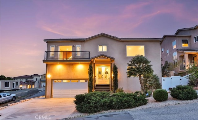 13083 Via Tuscany, Riverside, CA 92503 - view of front facade featuring a balcony, stucco siding, an attached garage, and concrete driveway