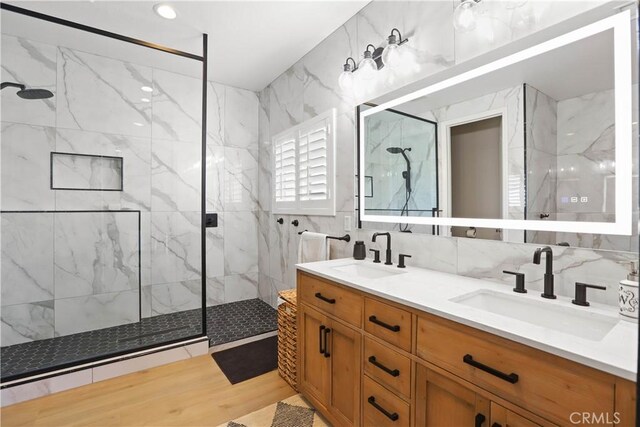 13083 Via Tuscany, Riverside, CA 92503 - full bath with a marble finish shower, double vanity, tile walls, wood finished floors, and decorative backsplash