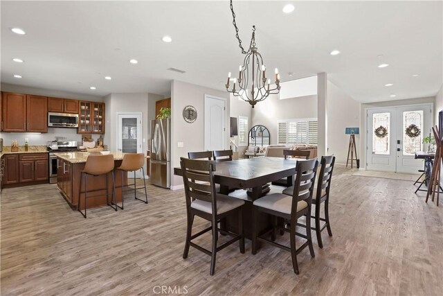 13083 Via Tuscany, Riverside, CA 92503 - dining room with light wood-style flooring, recessed lighting, a chandelier, and baseboards
